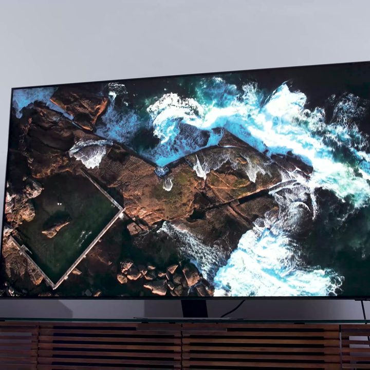 An aerial views of a coastline shown on a Samsung QN90C.