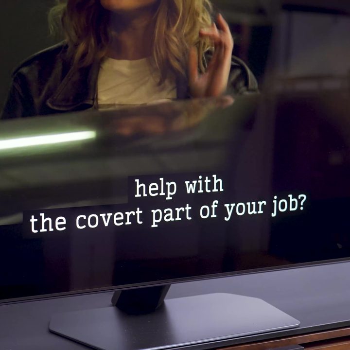 A close up of white closed captions on a Samsung QN90C.