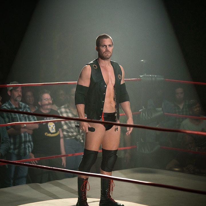 Stephen Amell stands in the center of a wrestling ring in Heels.