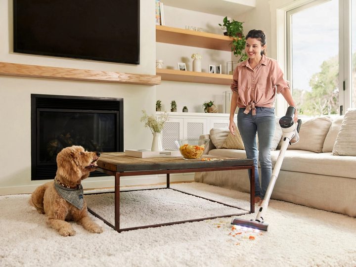 Tineco PURE ONE S15 Pet cordless stick vacuum cleaning near pup.