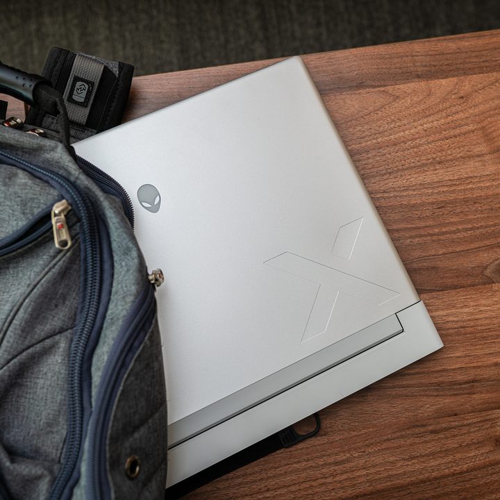 Alienware x16 hanging out of the backpack.
