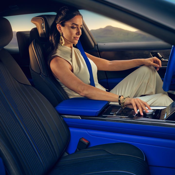 Cadillac CELESTIQ interior view of a woman driving and the passenger seat.