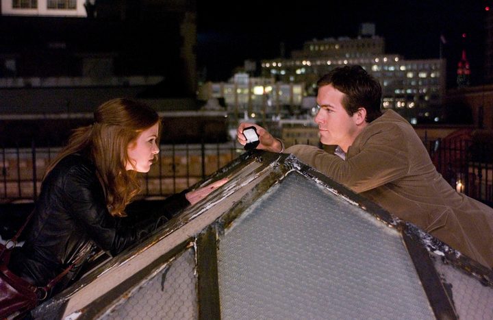 A man talks to a woman on a roof in Definitely, Maybe.