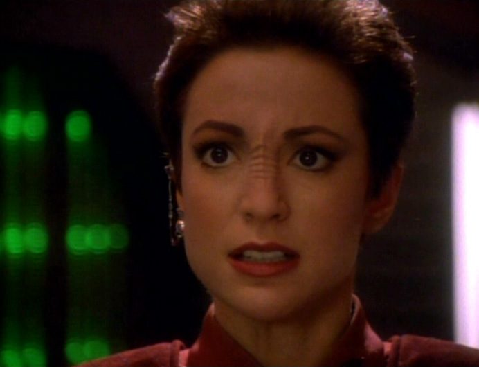 Major Kira Nerys looking upset in Deep Space 9's brig in the episode "Duet"