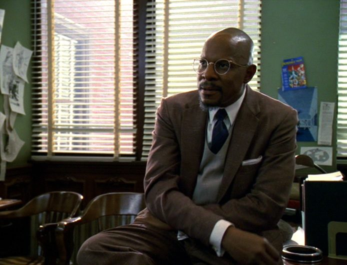 1950 science fiction author Benny Russell, who is identical to Captain Benjamin Sisko, sits in a publishing office in the DS9 episode "Far Beyond the Stars"