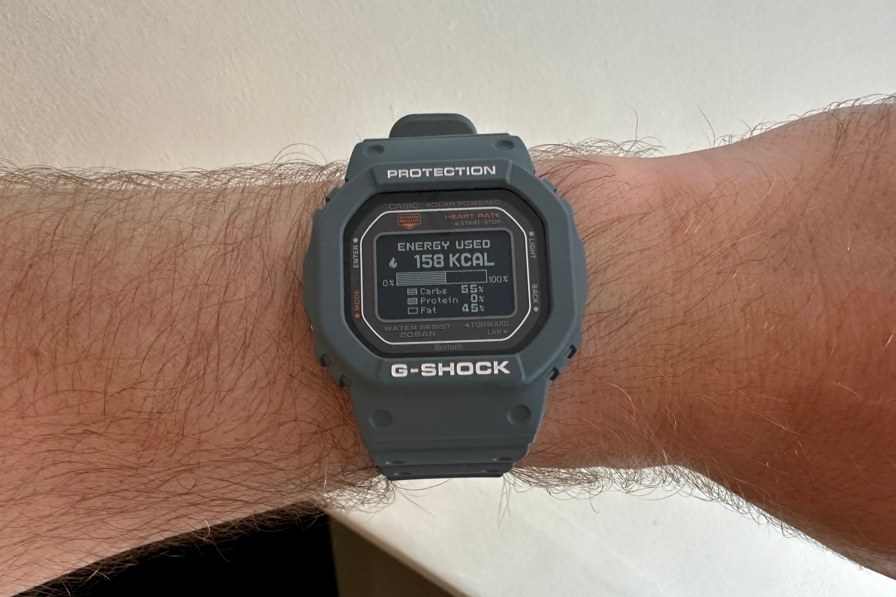 A person wearing the Casio G-Shock DW-H5600, showing workout energy data.
