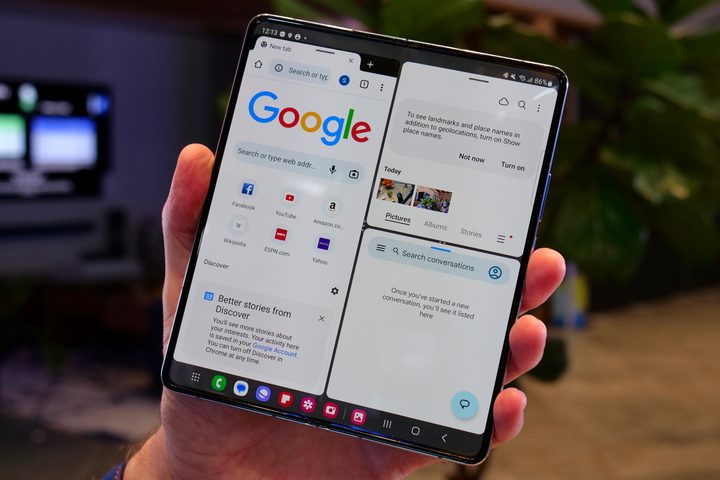 A person holding the Samsung Galaxy Z Fold 5, showing three apps running.