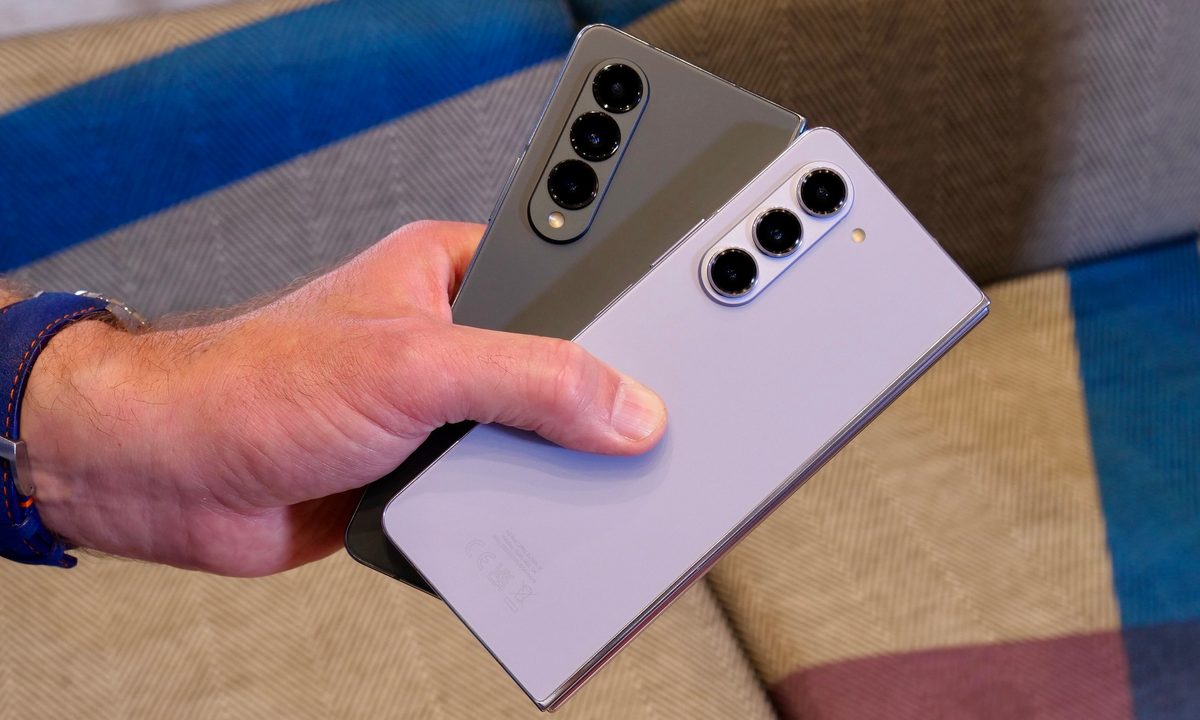 A person holding the Samsung Galaxy Z Fold 4 and Galaxy Z Fold 5.