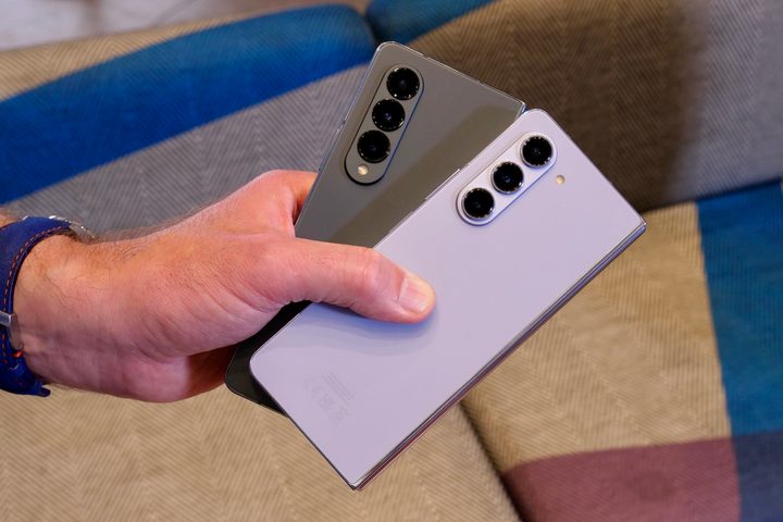 A person holding the Samsung Galaxy Z Fold 4 and Galaxy Z Fold 5.