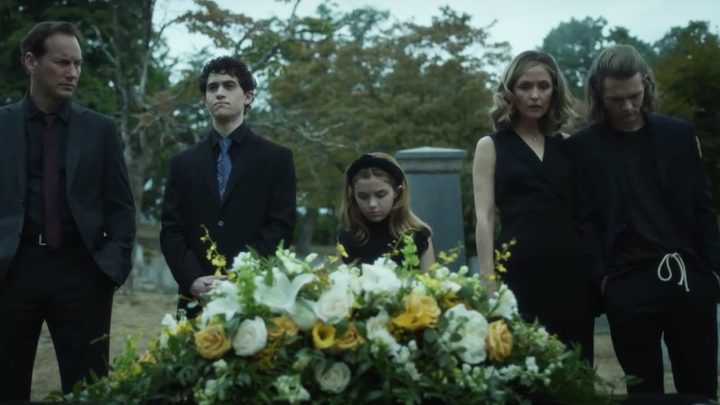 A family stands over an open grave in Insidious: The Red Door.