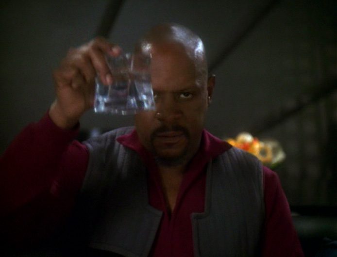 Captain Benjamin Sisko looks directly into the camera and grimly toasts his treacherous actions in DS9's "In the Pale Moonlight."