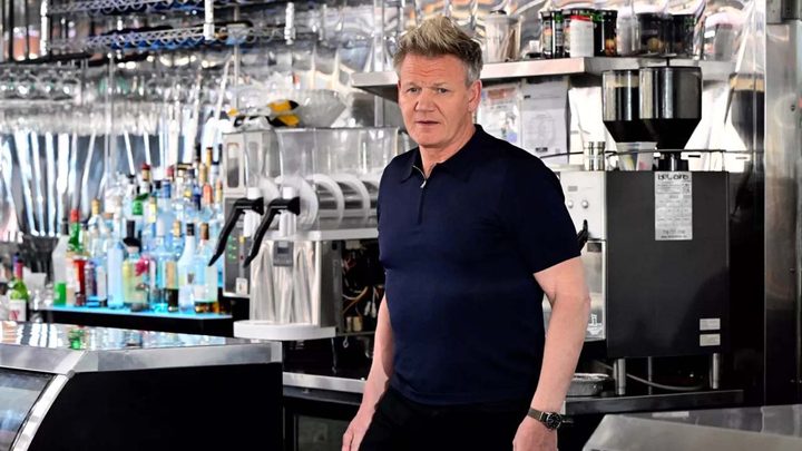Chef Gordon Ramsay standing in a kitchen in a scene from the original Kitchen Nightmares show.