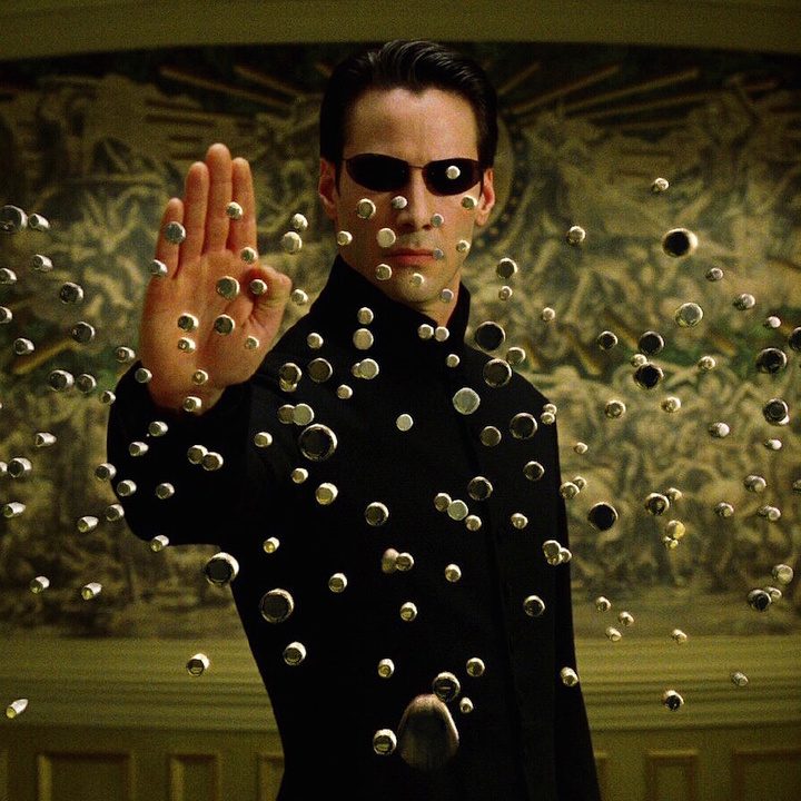 Keanu Reeves as Neo stopping dozens of oncoming bullets in The Matrix Reloaded