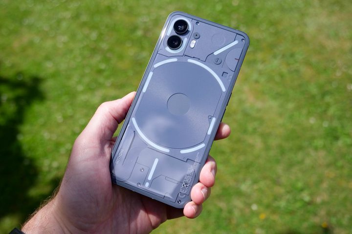 A person holding the Nothing Phone 2, with the lights lit up.