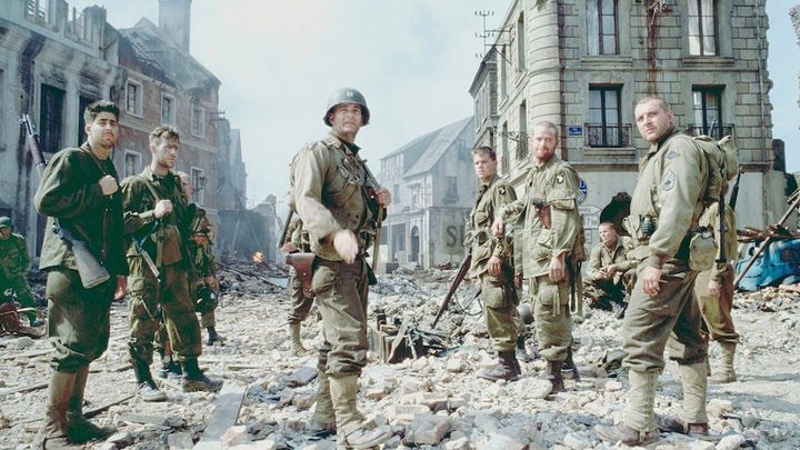 A group of soldiers stand in rubble in Saving Private Ryan.