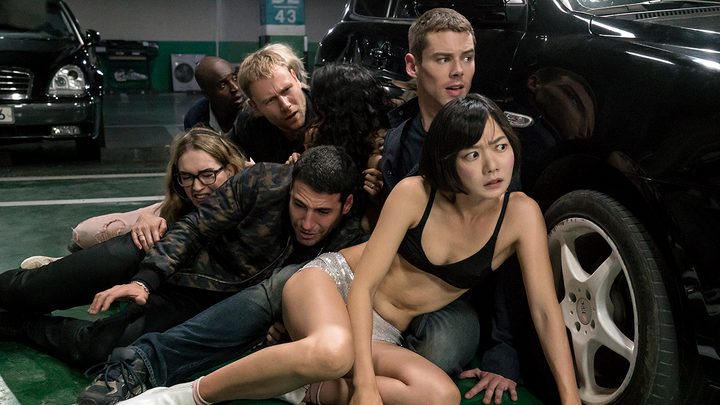 Doona Bae as Sun and the cast of Sense 8 hiding behind a car.