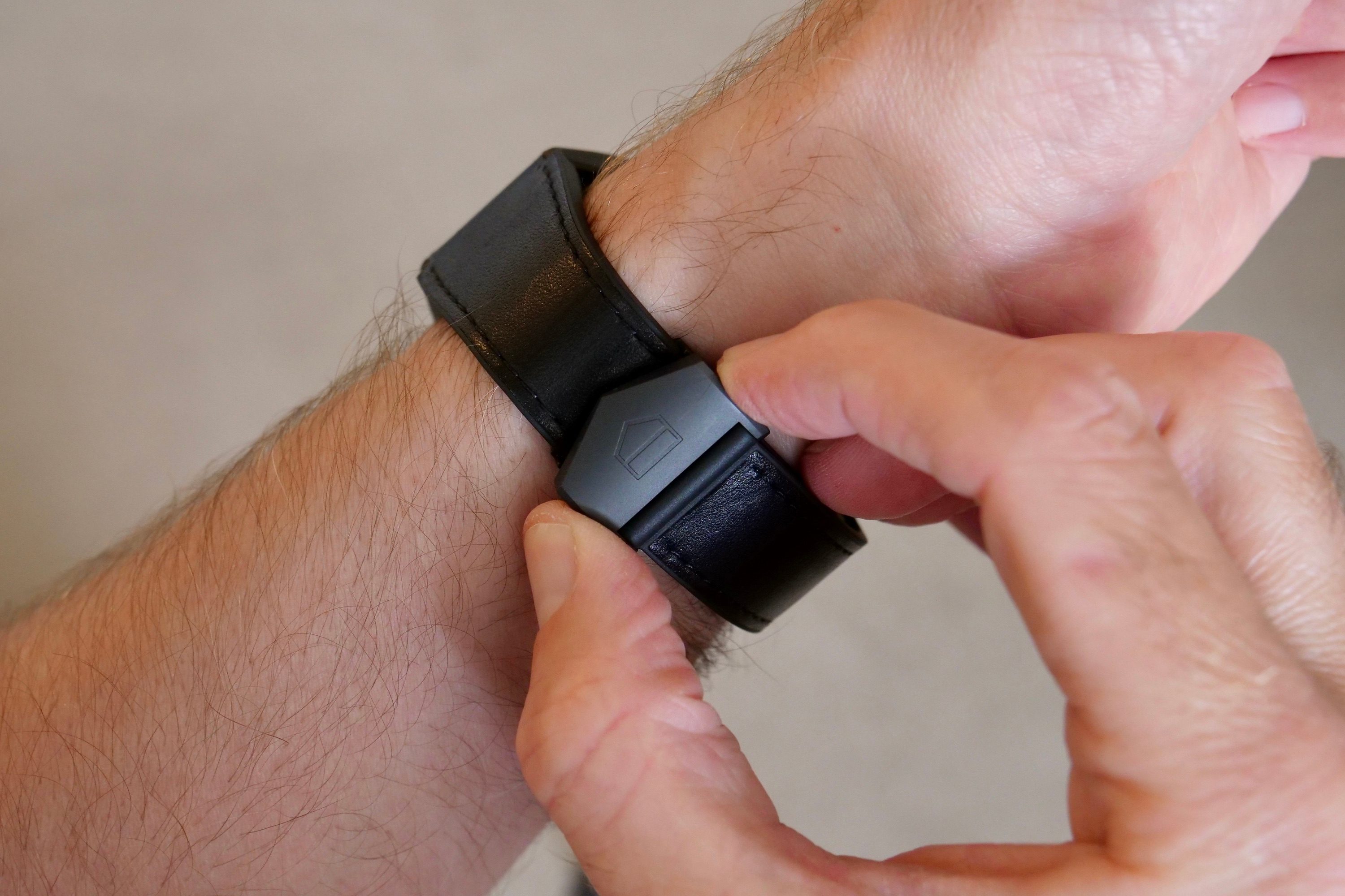 Undoing the clasp on the Tag Heuer Connected Calibre E4 Bright Black Edition.
