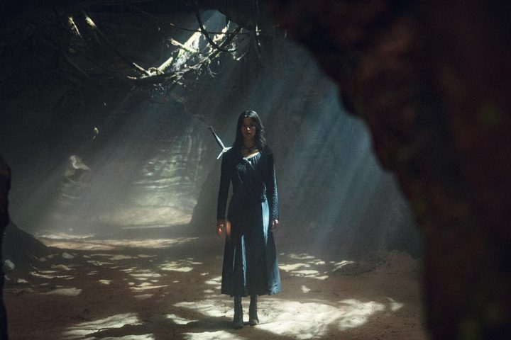 A woman walks through the woods in The Witcher season 3.