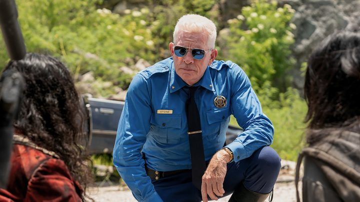 Agent Stone kneeling on the ground in a scene from Twisted Metal.