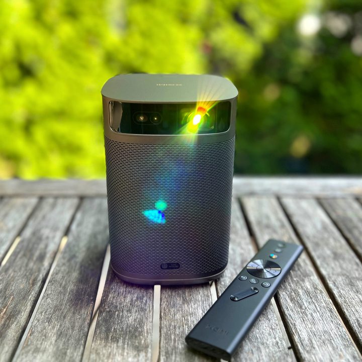 The MoGo 2 Pro projector with the lamp shining from the land.