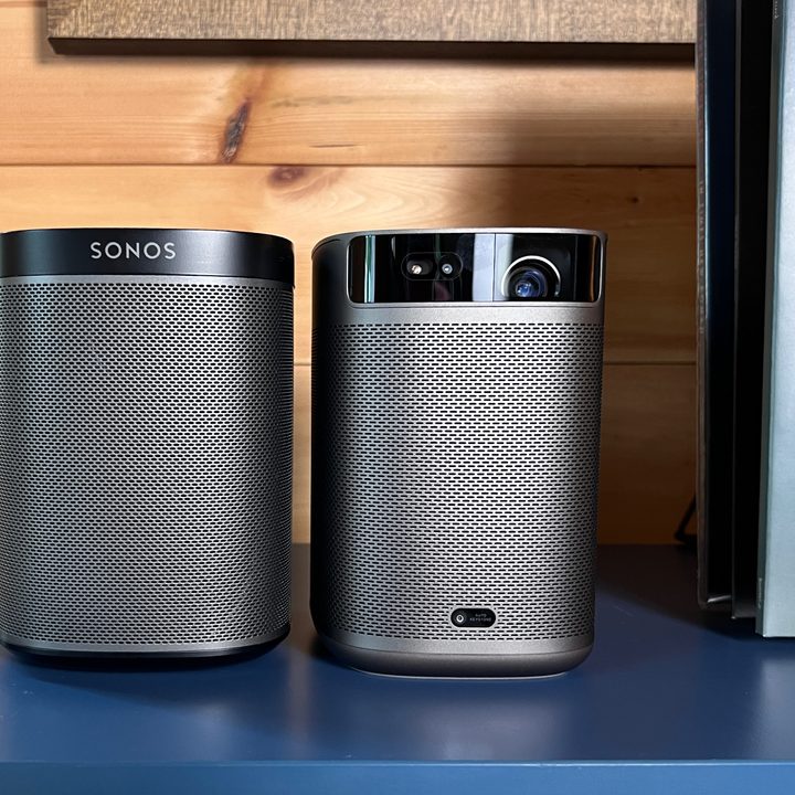 The Xgimi MpGo 2 Pro sitting alongside a Sonos Play:One speaker.