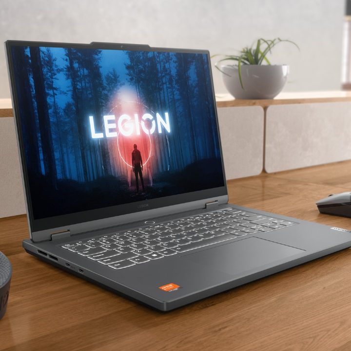 The Legion Slim 5 14 on a desk with peripherals on it.