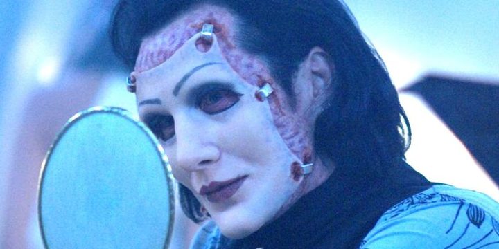 A man observes his new face in Repo The Genetic Opera