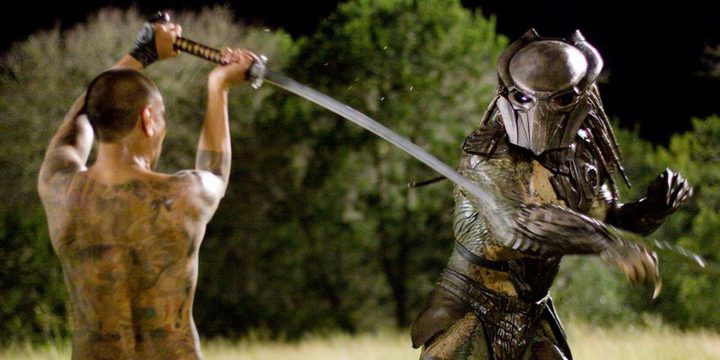 A man tries to kill a predator with a sword