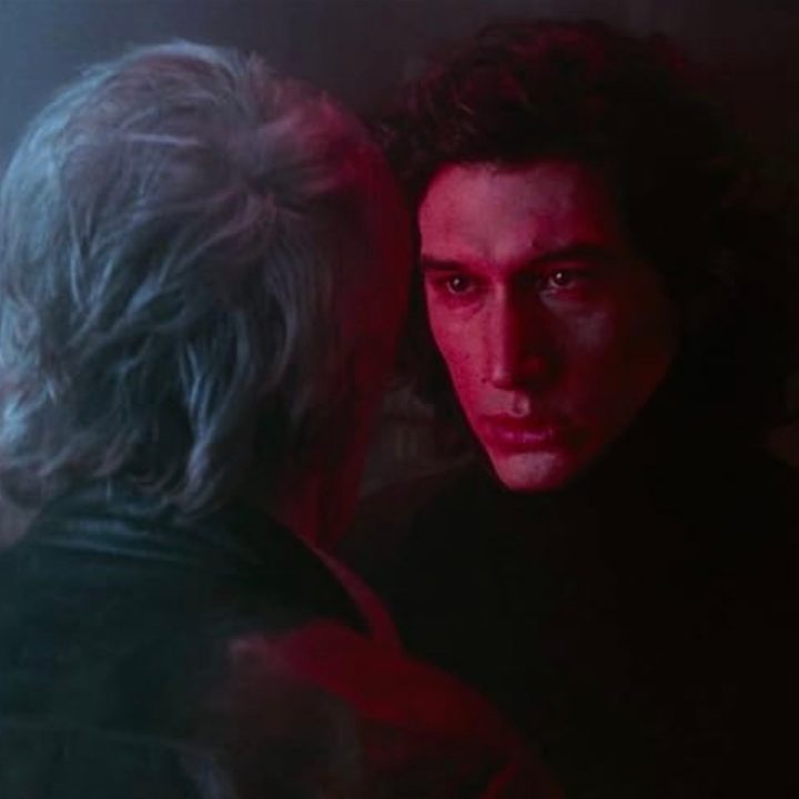 Adam Driver stands and stares at Harrison Ford in Star Wars: The Force Awakens.
