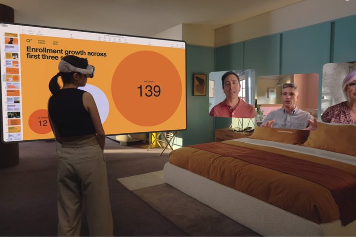 A person using an Apple Vision Pro headset to have a FaceTime video call with multiple people.
