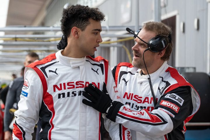 Archie Madekwe looks at David Harbour in Gran Turismo.