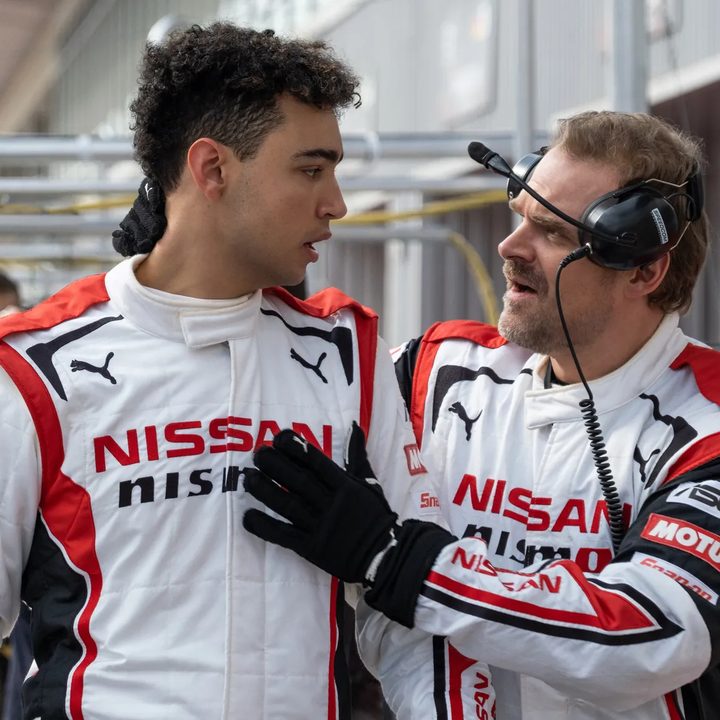 Archie Madekwe looks at David Harbour in Gran Turismo.