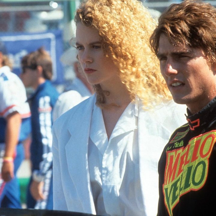 Nicole Kidman and Tom Cruise stand beside one another in Days of Thunder.
