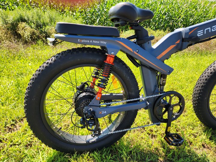 Engwe X24 rear wheel right side showing rear coil shocks and mid-frame shock.