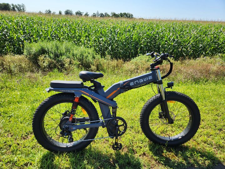 Engwe X24 right side full shot with cornfield background.
