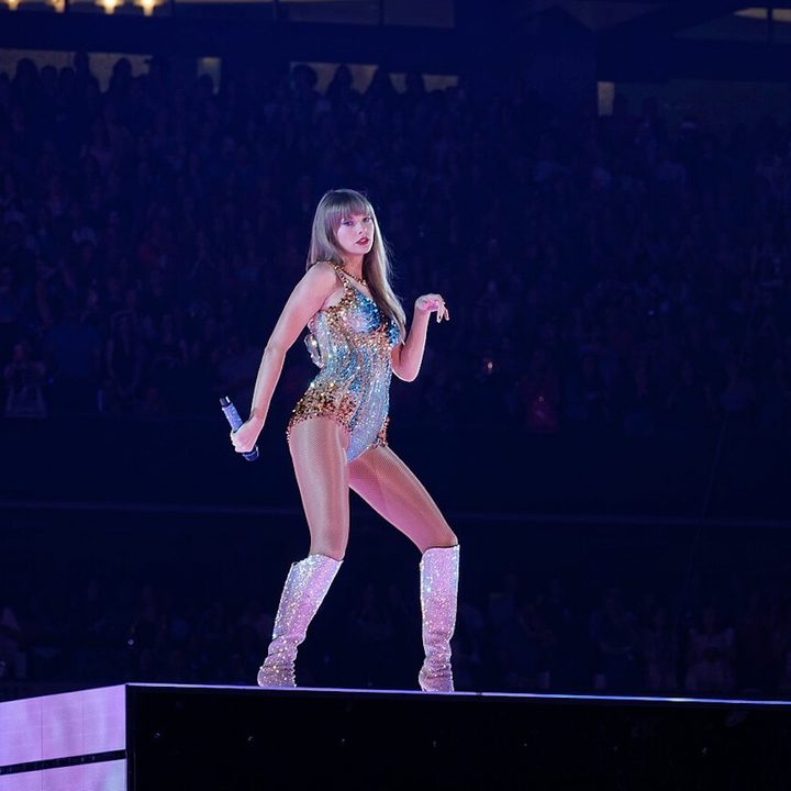 Taylor Swift stands onstage at the Eras Tour.