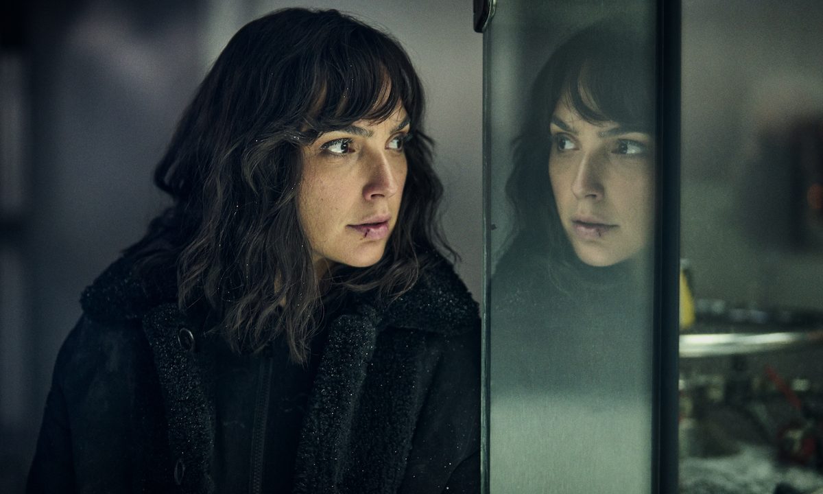 Gal Gadot stands against a mirror in Heart of Stone.