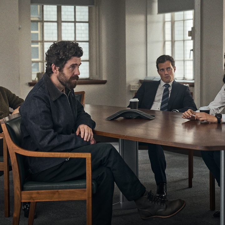 A group of professionals sit around a table.