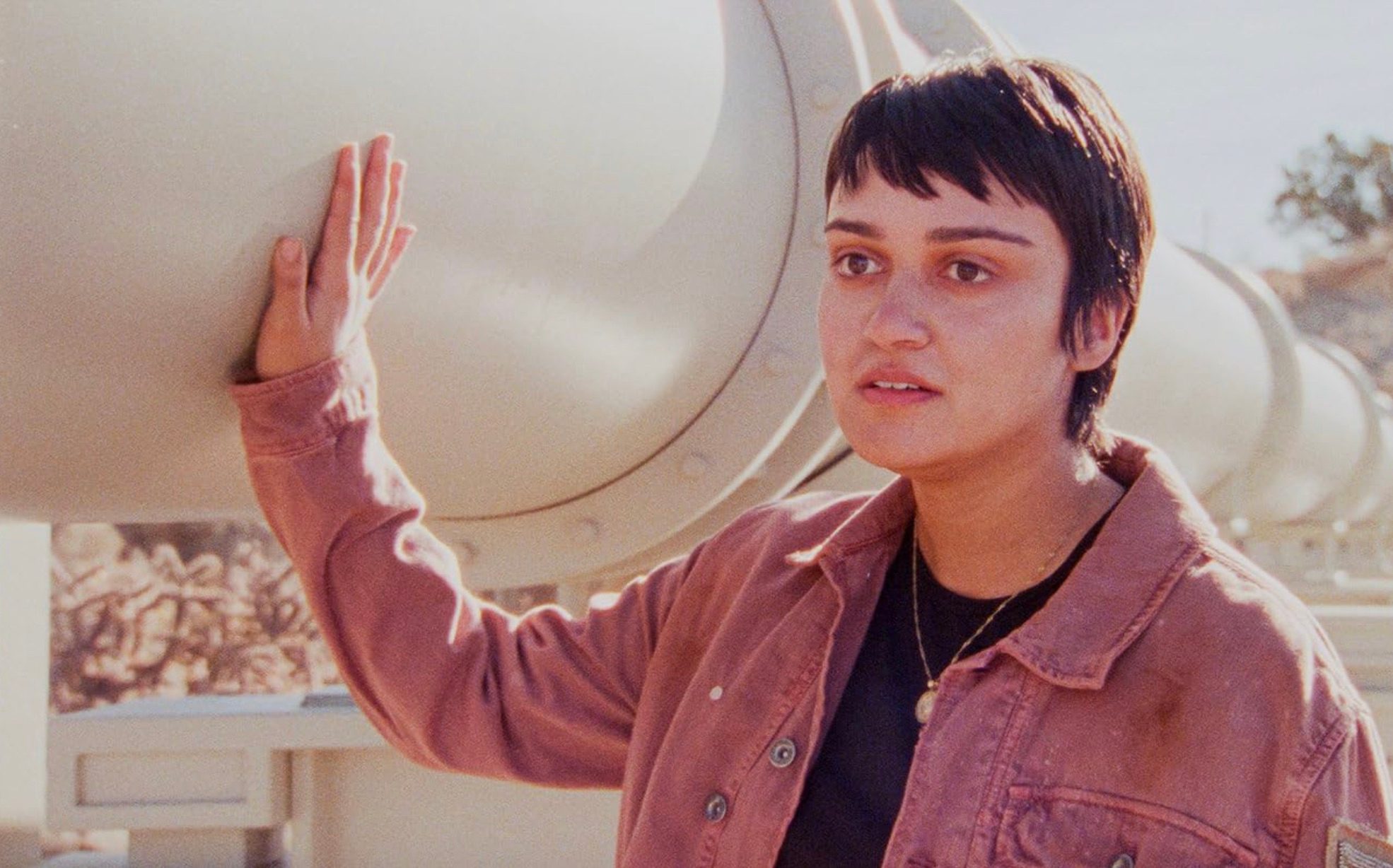 A woman touches a pipeline in How to Blow Up a Pipeline.