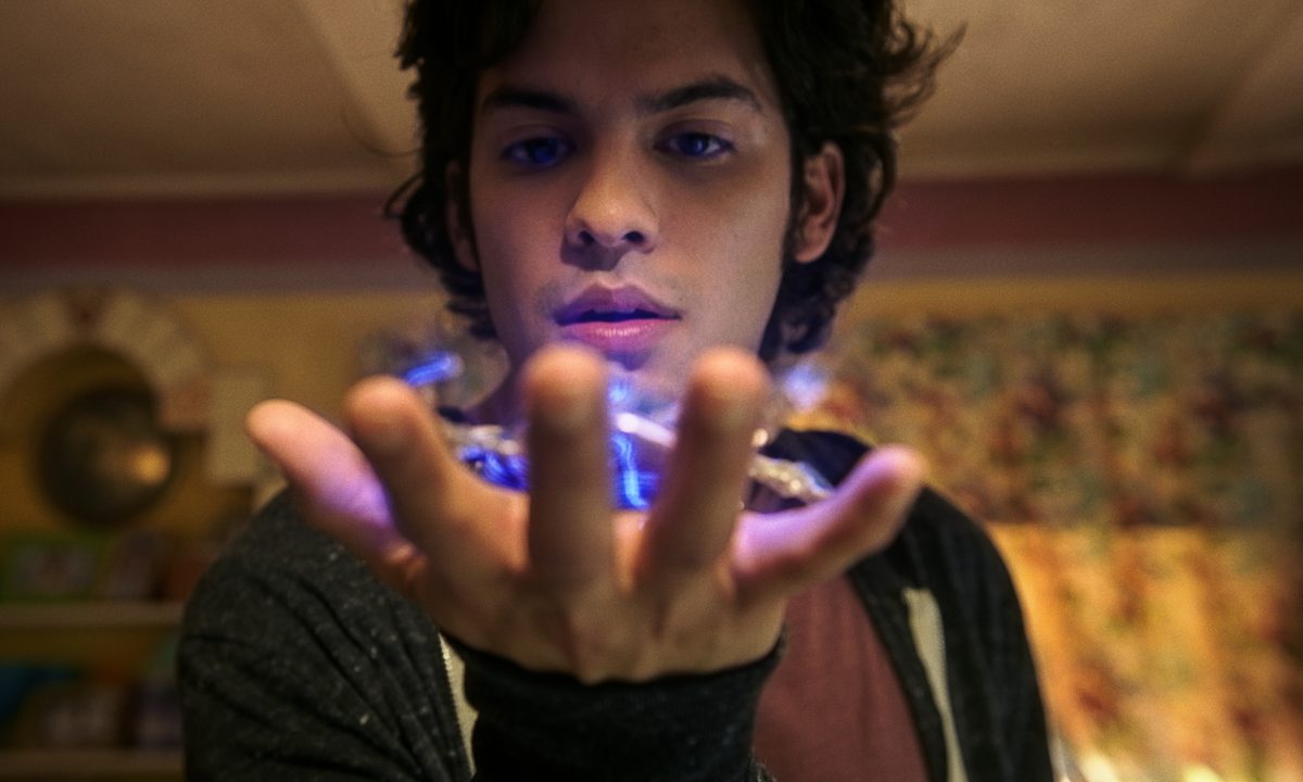 Jaime Reyes holds the scarab in Blue Beetle.