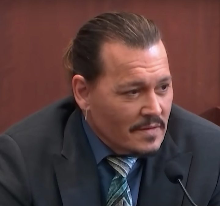 Johnny Depp sits on the stand in court in Depp v. Heard.