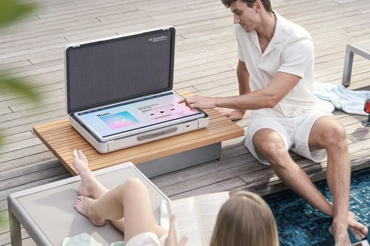 LG StanbyMe Go 27-inch touchscreen suitcase TV playing music.
