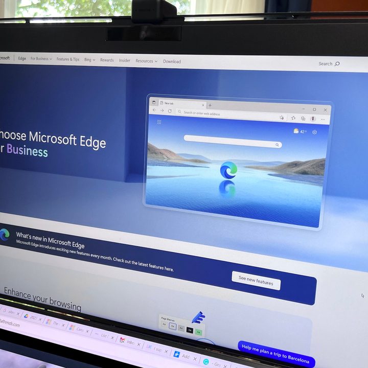 Microsoft Edge appears on a computer screen with plants and a window in the background.