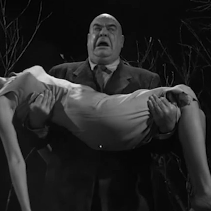 A man holding a woman's body in his arms in "Plan 9 from Outer Space."