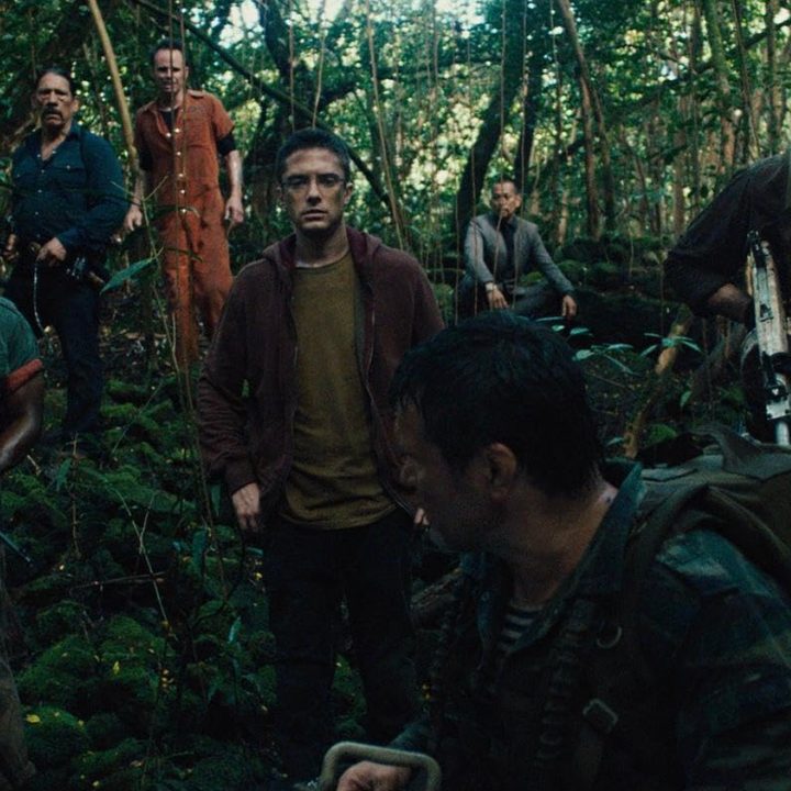 A group of hunters band together and hold guns in the jungle in Predators.