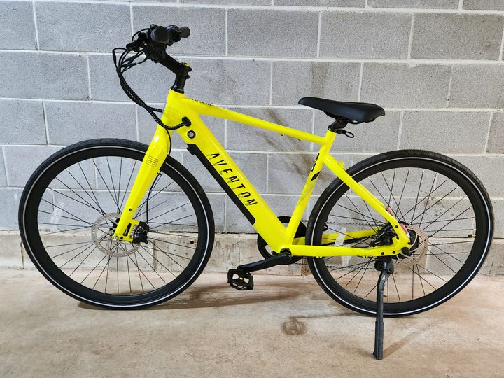 The Aventon Soltera.2 left side profile shot against a concrete brick wall.