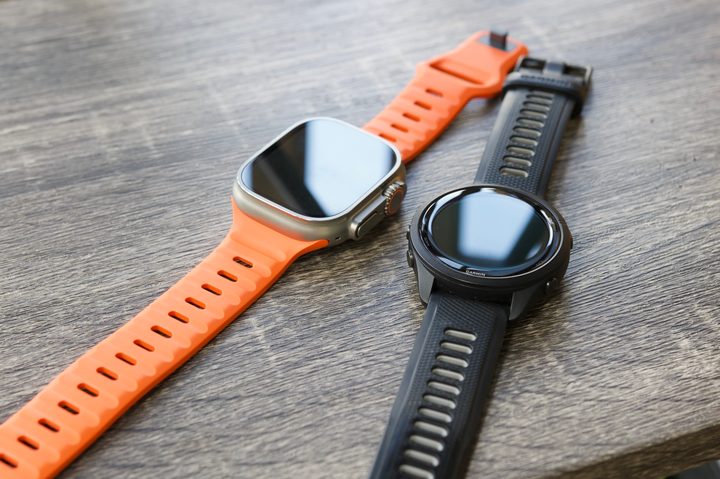 Apple Watch Ultra next to the Garmin Forerunner 265.
