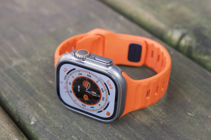 Overhead view of an Apple Watch Ultra resting on a wooden patio.
