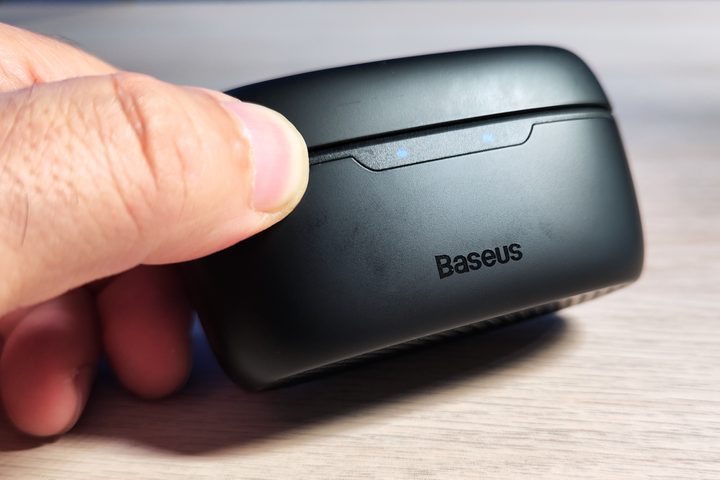 Baseus Bowie MA10 charging case with charging LED indicators lit.