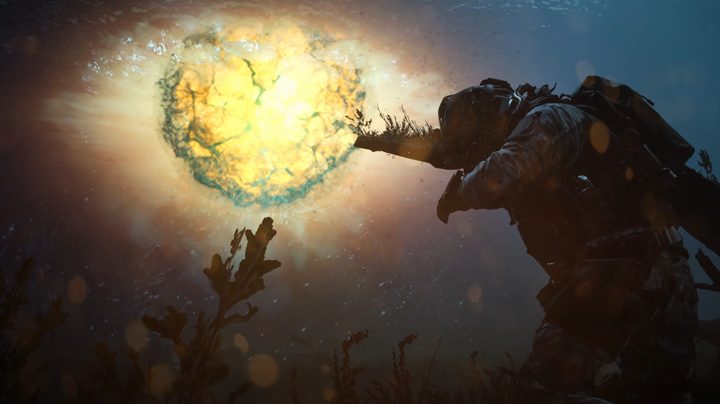 A soldier shields themself from an underwater explosion.